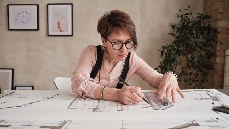 An architect working on drawings at their desk