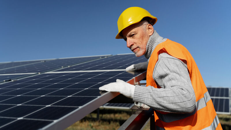 An engineer conducting regular maintenance on solar panels